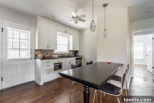 Bright and airy living space within the updated duplex unit, featuring fresh paint and ample natural light.