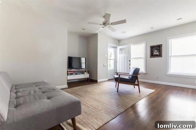 Spacious, updated kitchen with black granite countertops, new cabinets, and a built-in dining area in the renovated duplex unit.