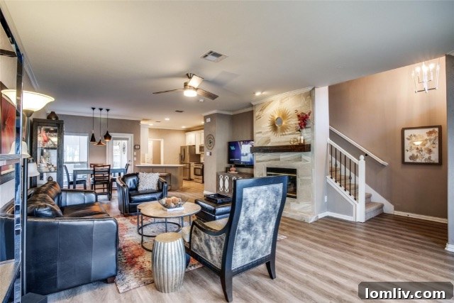 $375K Dilemma Oak Lawn Townhome or McKinney Condo 5 An inviting living room in the McKinney townhome, featuring luxury vinyl plank flooring and contemporary decor, showcasing comfort.