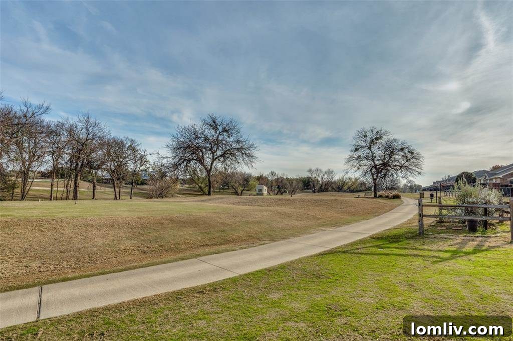 Modern townhome exterior with stone accents and a well-maintained lawn, characteristic of Fairway Villas at Ridgeview Ranch