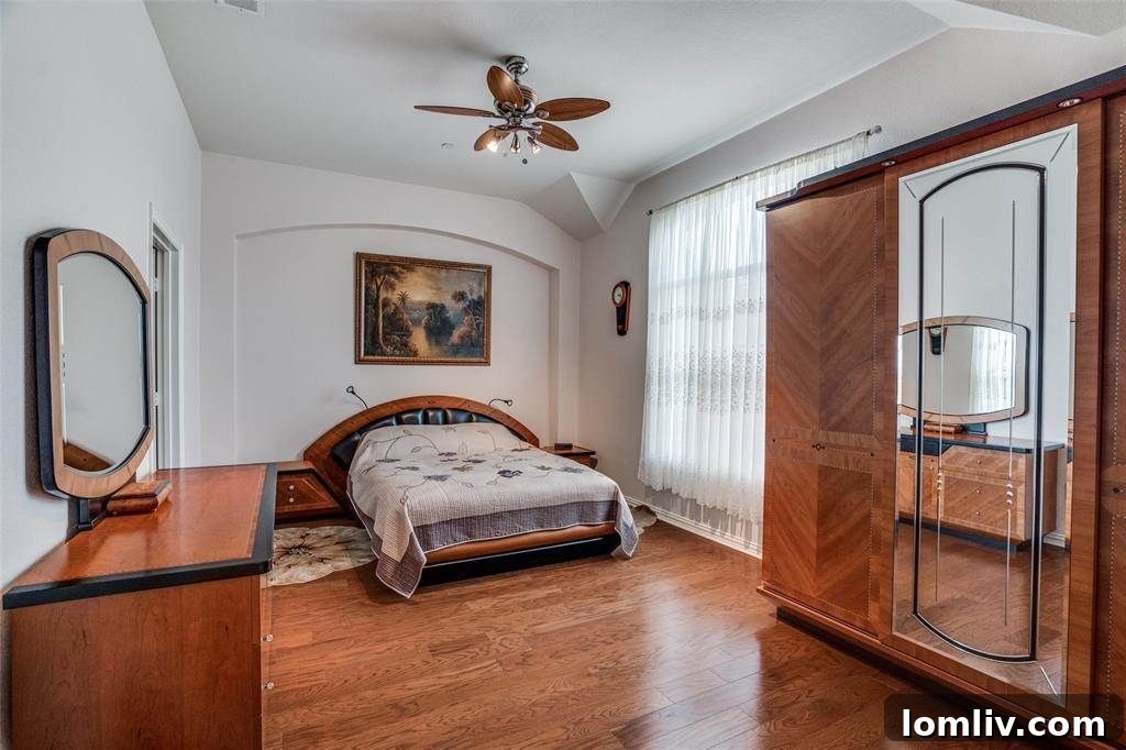 Modern kitchen with granite countertops, stainless steel appliances, and ample cabinet space, opening to a dining area
