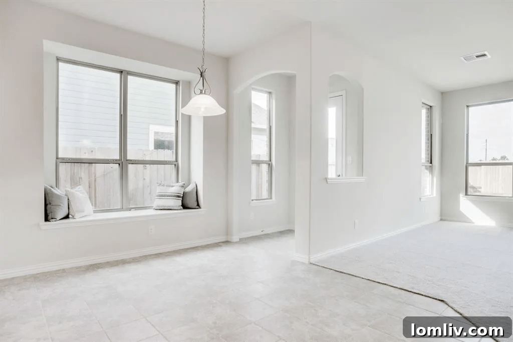 Elegant living room with high ceilings, fireplace, and large windows.