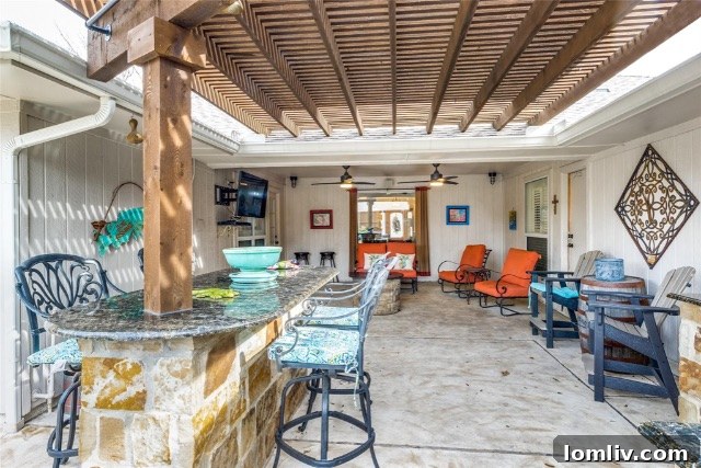 An inviting covered patio area, perfect for outdoor relaxation and dining, featuring comfortable seating and decorative elements.