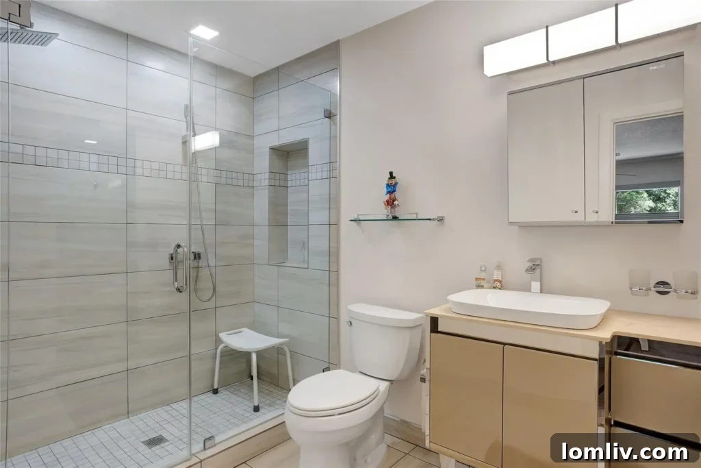 The spacious glass-walled walk-in shower in the primary bathroom.