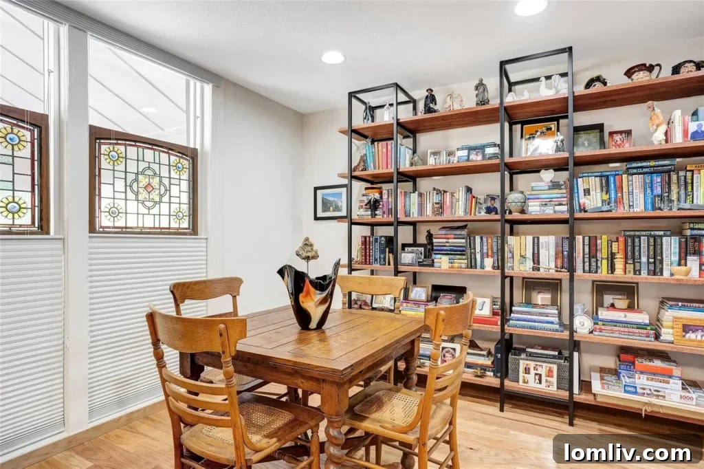 The primary bedroom, featuring expansive windows that invite nature indoors.