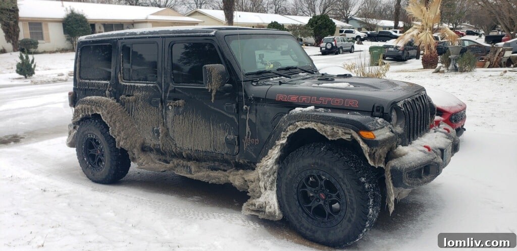 Patrick Abell assisting a stranded motorist whose car is stuck in a ditch on an icy road in Dallas.