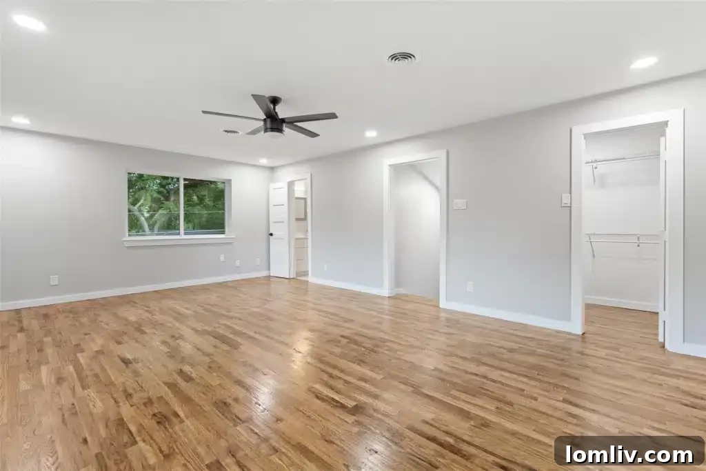 Spacious upstairs game room or secondary living area with vaulted ceilings, large windows, and an inviting, versatile layout.