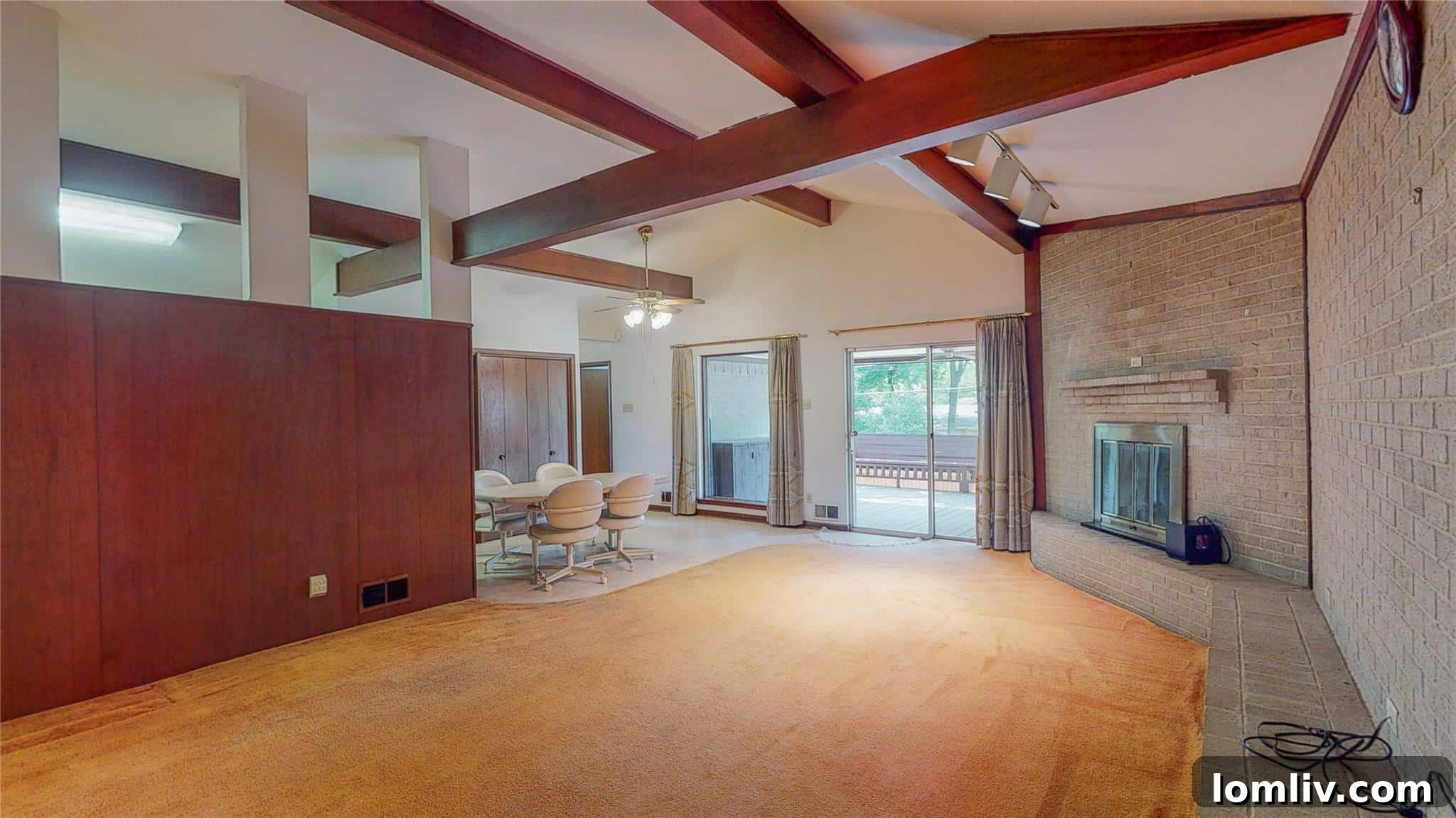 Before and after comparison: a dimly lit, carpeted living area with a fireplace transformed into an open, airy space with light wood floors and updated fixtures.