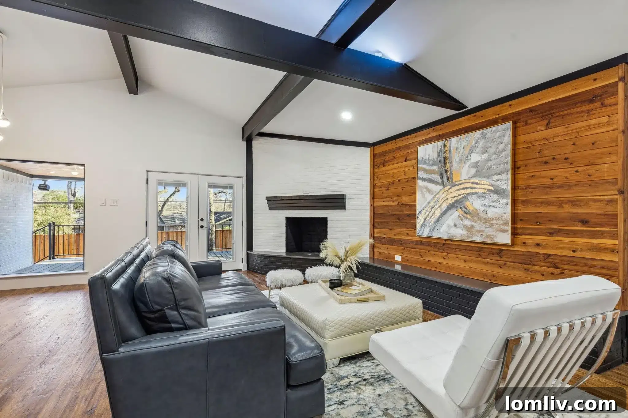 Before and after comparison: a dimly lit, carpeted living area with a fireplace transformed into an open, airy space with light wood floors and updated fixtures.