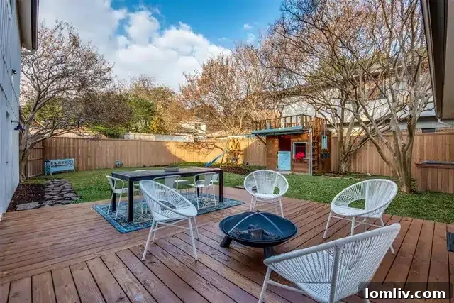 Overview of the spacious backyard with deck and playscape