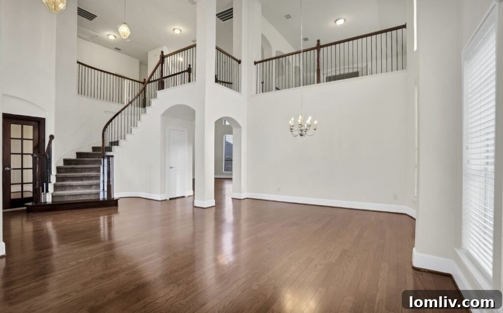 Spacious living room with high ceilings and natural light.