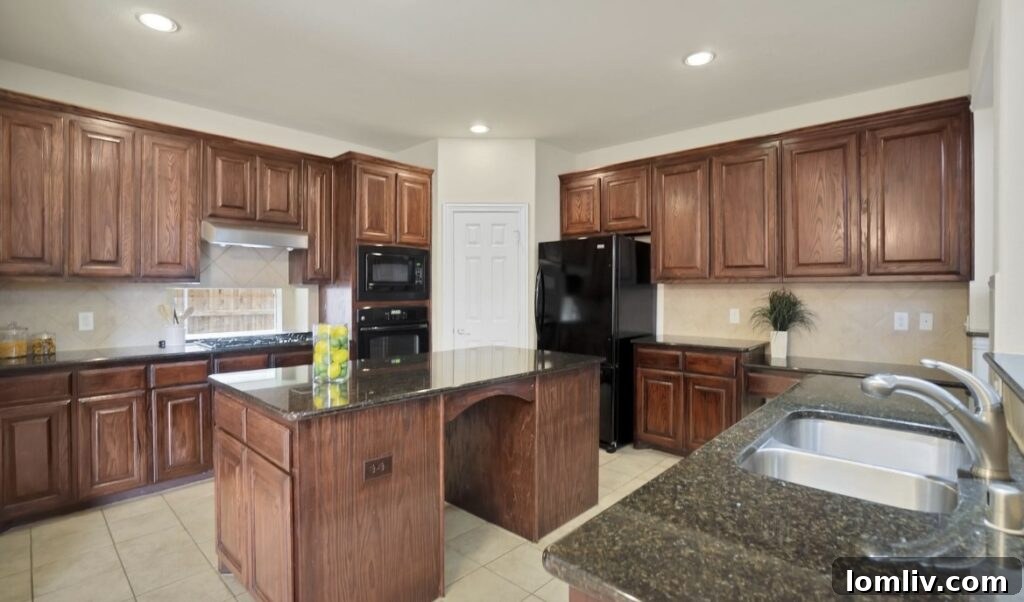 Modern kitchen with large island and ample counter space.