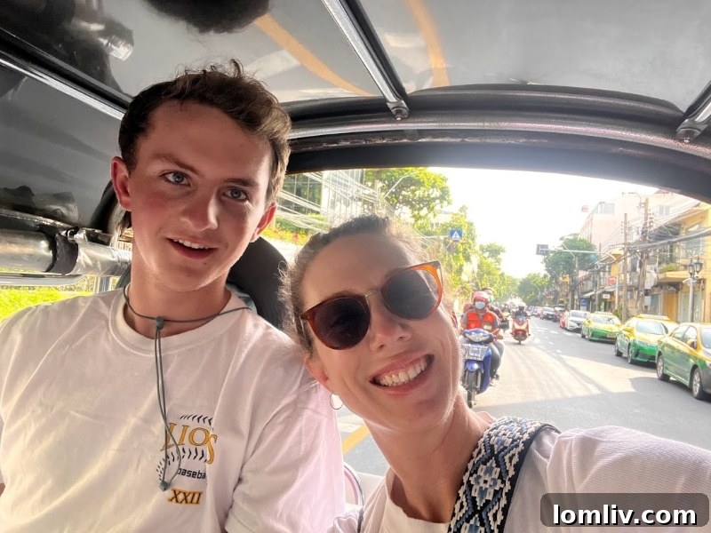 GlobeAware Dallas: Pioneering Life-Changing Voluntourism Experiences 5 Deb Young and her son Toby interacting with locals in Thailand.