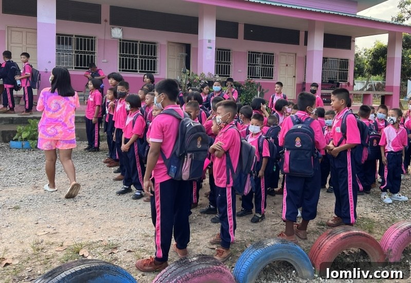 GlobeAware Dallas: Pioneering Life-Changing Voluntourism Experiences 6 Deb Young and Toby Young smiling with local children in Thailand.