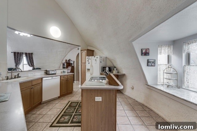 A modern and creatively designed kitchen within a monolithic dome home at 120 Dome Park Place, featuring unique angles and custom cabinetry.