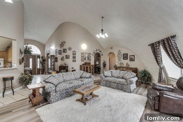 An aerial view of multiple white Monolithic Domes nestled among lush green trees, likely in a tropical or coastal setting.