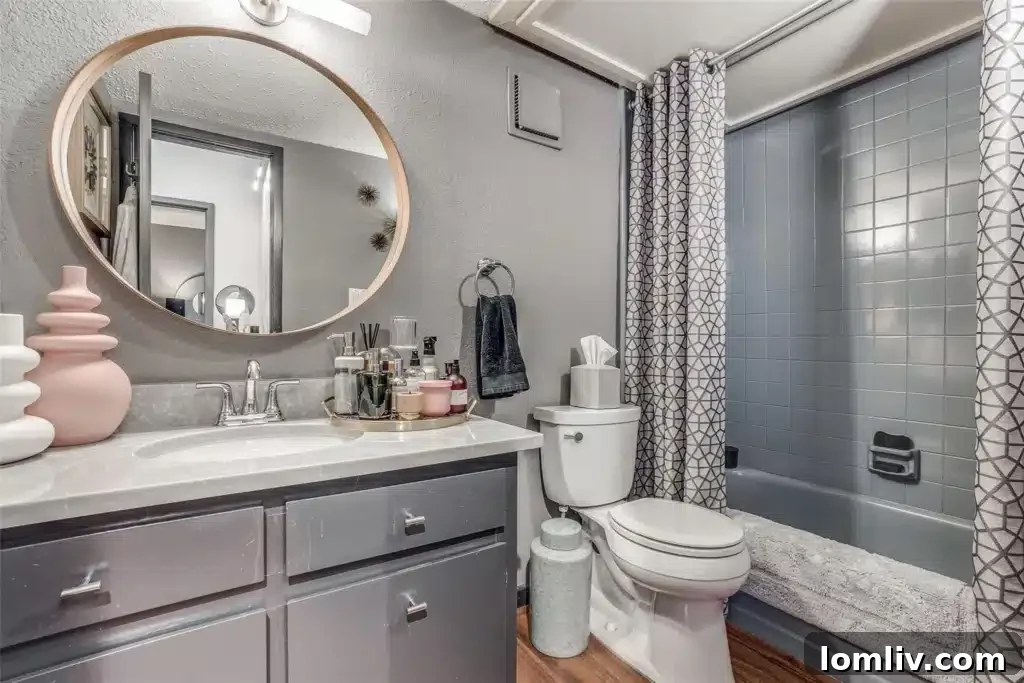 Oaklawn's Oglesby Gem: A Tranquil Escape 12 Adjoining bathroom for the second bedroom, maintaining the home's contemporary aesthetic.