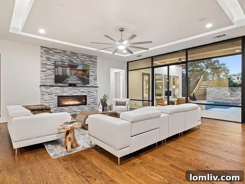 Expansive living room with floor-to-ceiling windows offering panoramic views of Lake Grapevine and the surrounding nature.