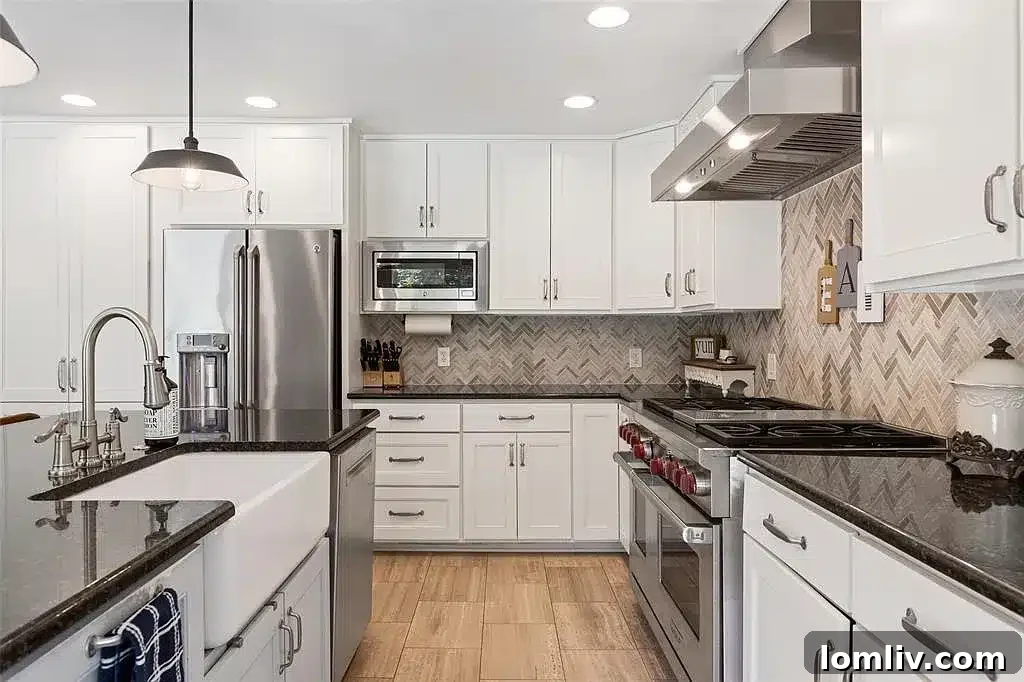 Well-appointed kitchen featuring custom cabinetry, granite countertops, and modern appliances.