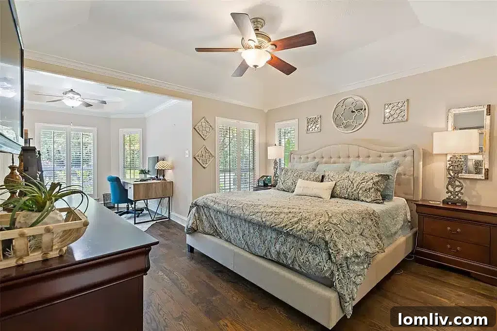 Expansive outdoor pool area with integrated spa, surrounded by lush landscaping, ideal for entertaining.