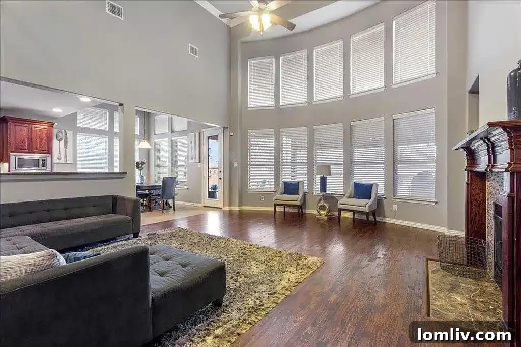 Inviting living room with fireplace and views of the backyard oasis in an Allen family home