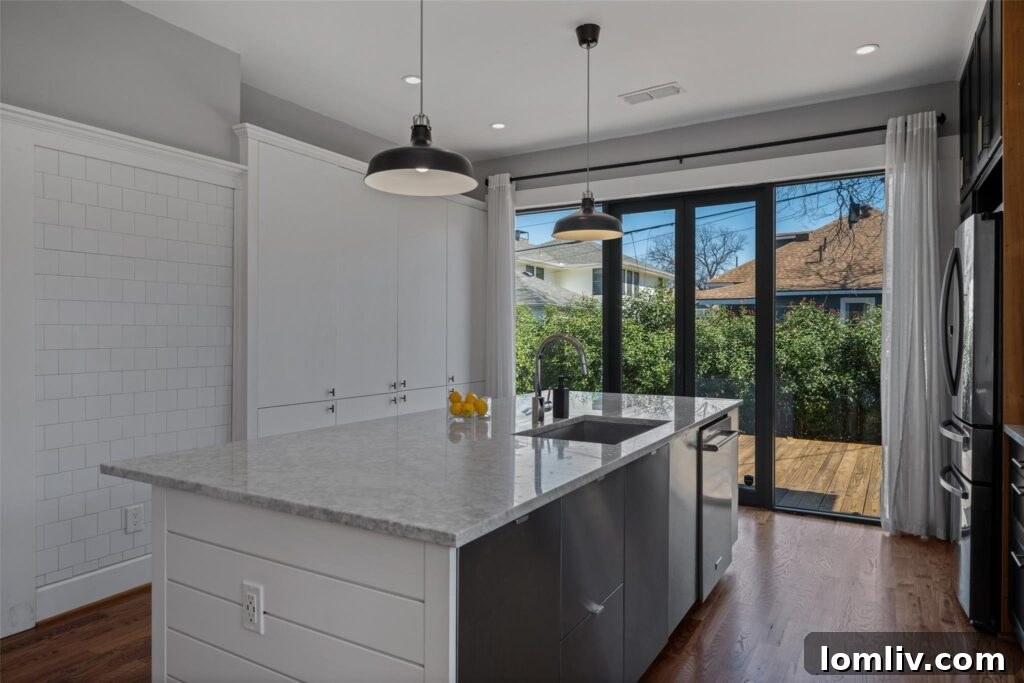 Modern White Kitchen with Subway Tile and Outdoor Access