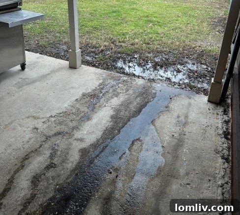 Water pooling near home foundation due to negative drainage