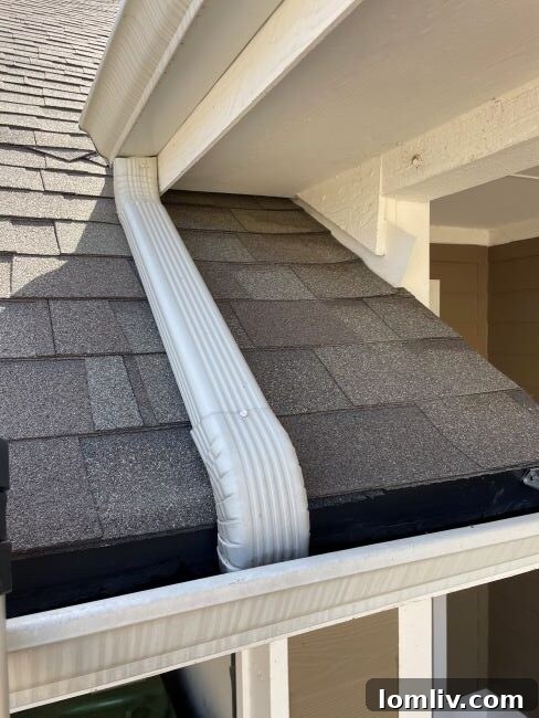 Correctly installed downspouts extending away from a house foundation