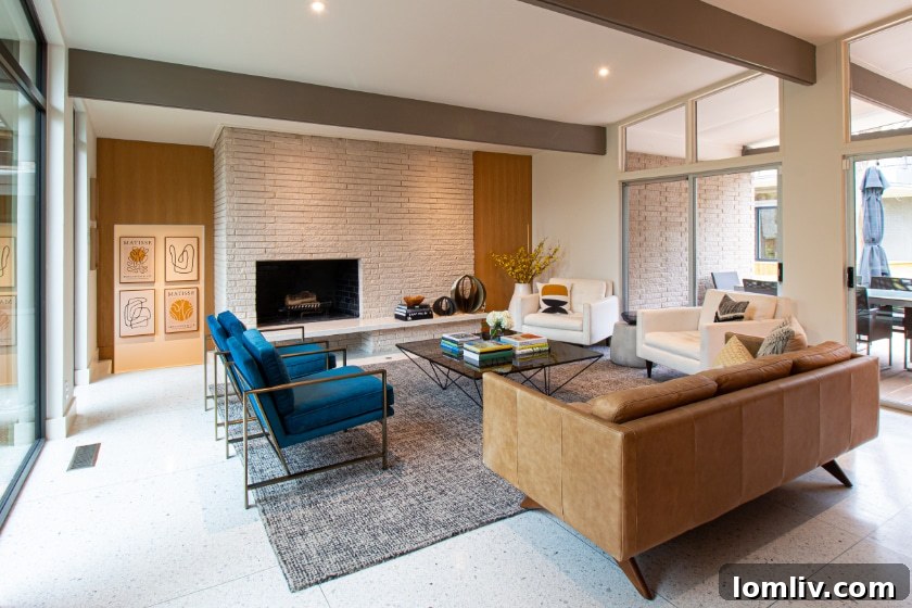The sunroom of the Ju-Nel home, featuring a floating brick fireplace with a terrazzo hearth and a wall of clerestory windows, allowing abundant natural light.