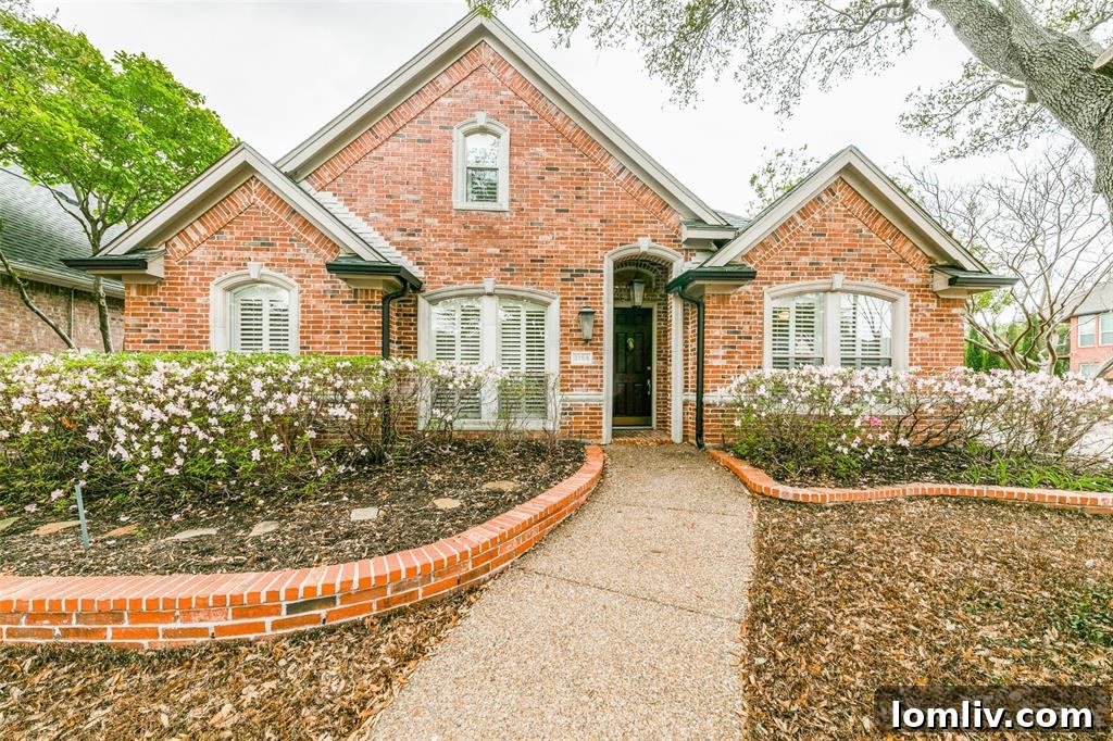 Exterior view of an updated traditional home at 3764 Park Pl, Addison, TX, featuring mature trees and a charming facade.