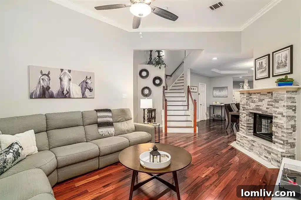 Bright and airy open-concept living area with a dual-sided fireplace in the Addison home.