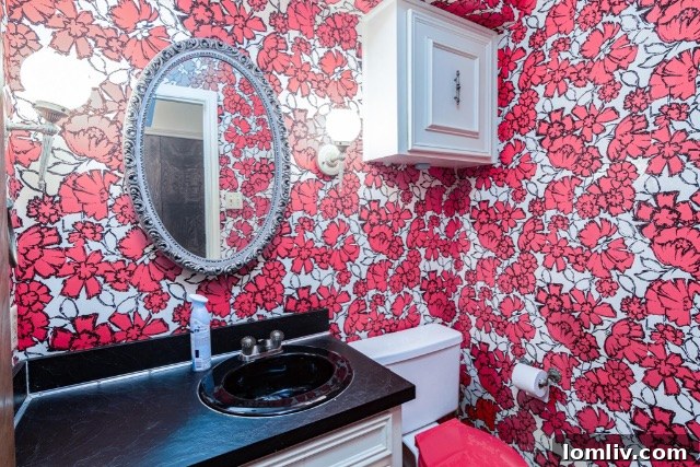A spacious living area inside the 1970s home, featuring vaulted ceilings and unique period details.