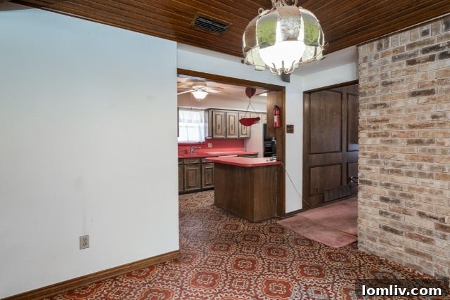 The vibrant red poppy wallpaper extending across the half-bath, complete with matching accessories.