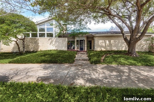 A charming 1970s Merriman Park home exterior with mature trees and a welcoming facade, hinting at cherished memories within.