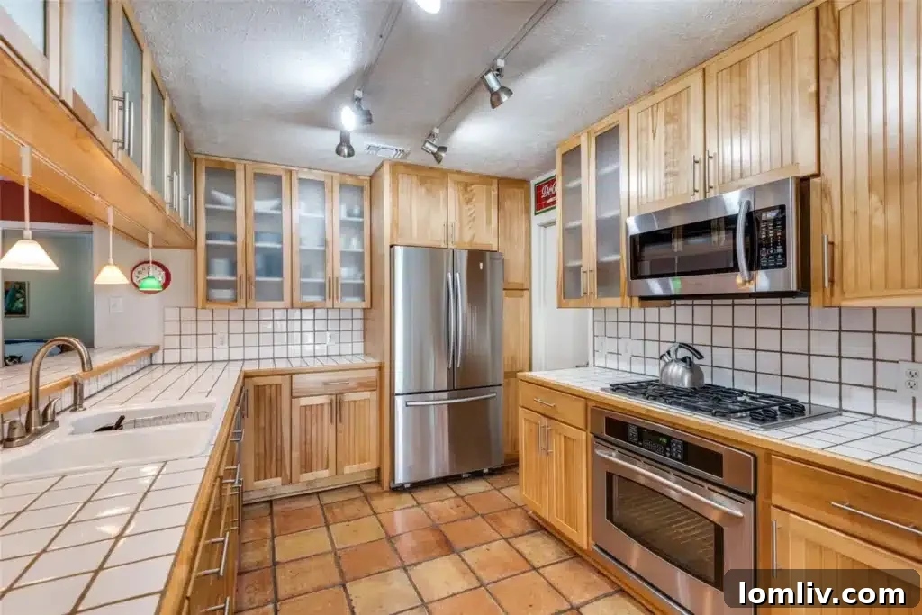 The exquisitely updated kitchen with custom cabinetry, modern countertops, and hand-laid Mexican tile in this Merriman Park gem.