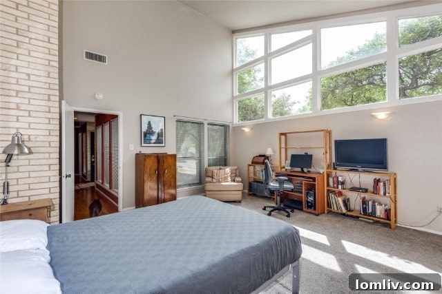 The inviting primary bedroom features stunning clerestory windows and ample space for relaxation in this Merriman Park home.