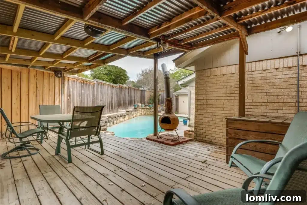 The spacious and inviting covered patio, ideal for alfresco dining and relaxation by the pool in Merriman Park.