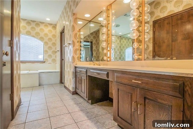 Fort Worth's Rare Single-Level Gem in a Gated Oasis 11 Before photo of primary bathroom vanity with dated bubble lights