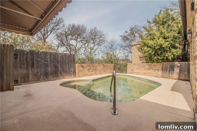 Fort Worth's Rare Single-Level Gem in a Gated Oasis 16 After photo of renovated private pool area with modern landscaping