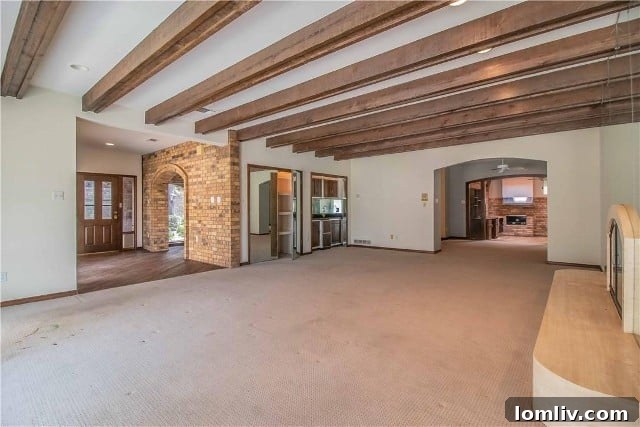 Fort Worth's Rare Single-Level Gem in a Gated Oasis 5 Before photo of living area with dark wood beams