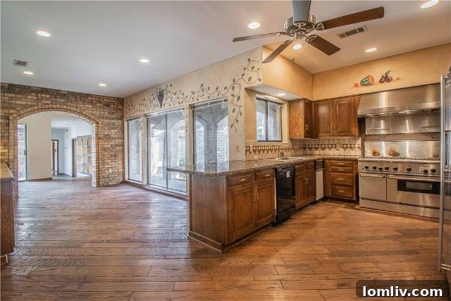 Fort Worth's Rare Single-Level Gem in a Gated Oasis 9 Before photo of kitchen with dark cabinets and taupe tones