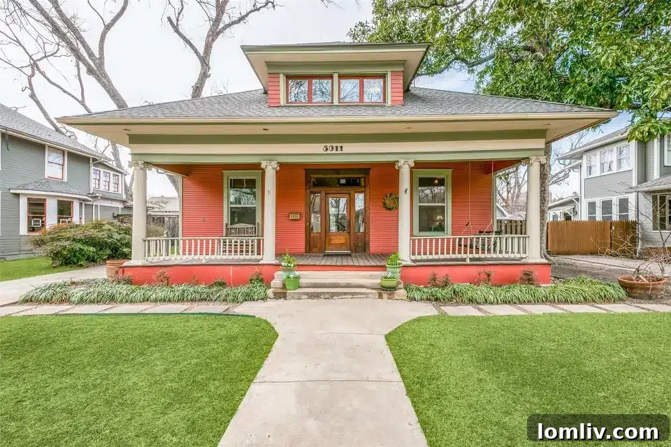 Experience North Texas: World-Class Porch Sitting Awaits at Open Houses 6 A beautiful coral-colored historic home in Dallas with a charming front porch, boasting significant curb appeal.