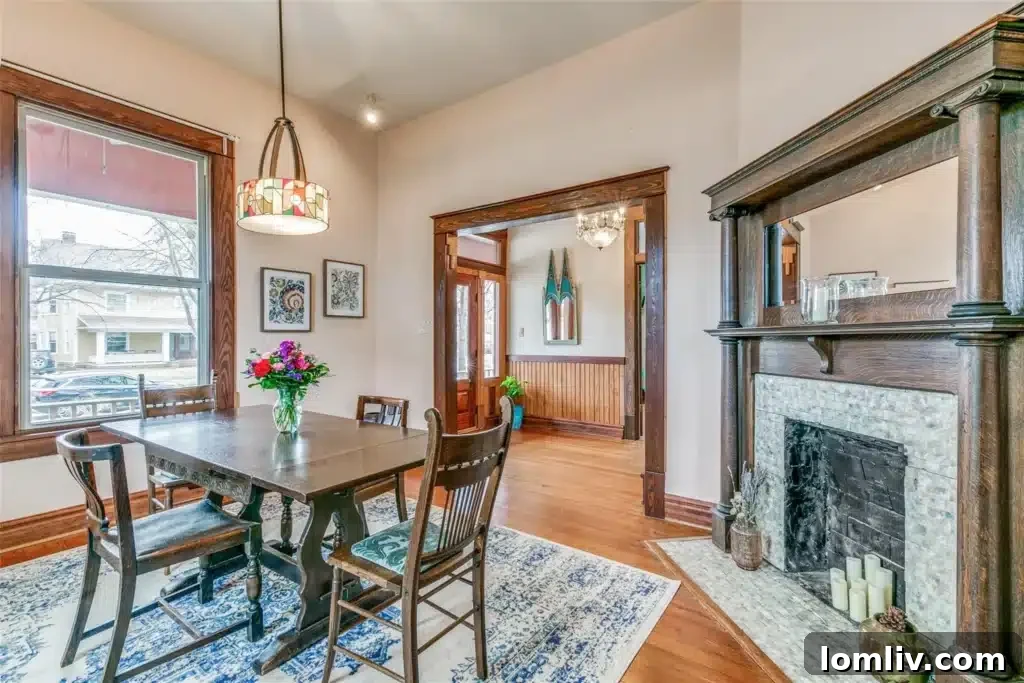 Experience North Texas: World-Class Porch Sitting Awaits at Open Houses 7 A cozy dining room with a fireplace in a historic Dallas home, perfect for intimate gatherings.