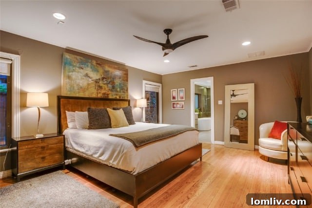 Elegant primary bedroom with warm tones and large windows