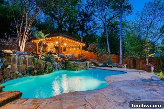 Beautiful outdoor pool area with a waterfall and comfortable seating