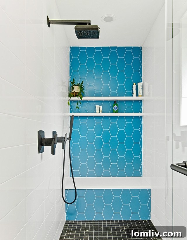 After photo of a luxurious midcentury modern bathroom with blue accent tiles