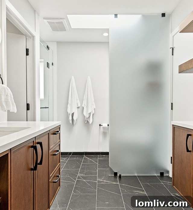 Detailed view of floating wood vanity and modern fixtures in a renovated bathroom