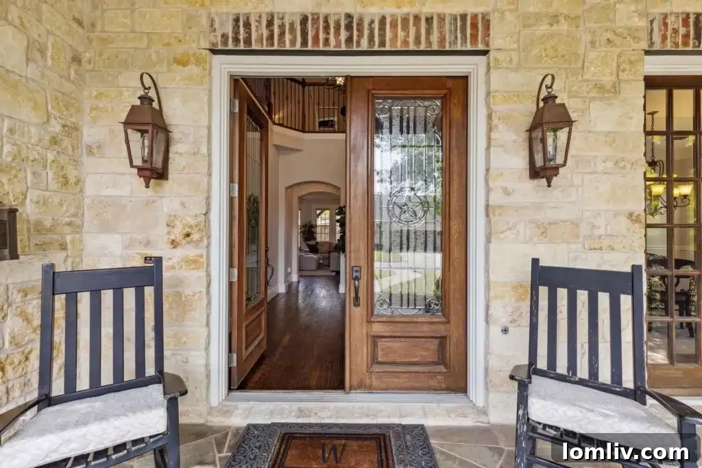 Close-up of the elegant front door and arched entryway of 10616 Lathrop Drive