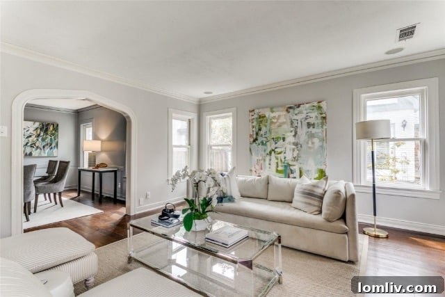 Detailed view of the front porch with a wood door and stained glass windows on a classic Tudor home