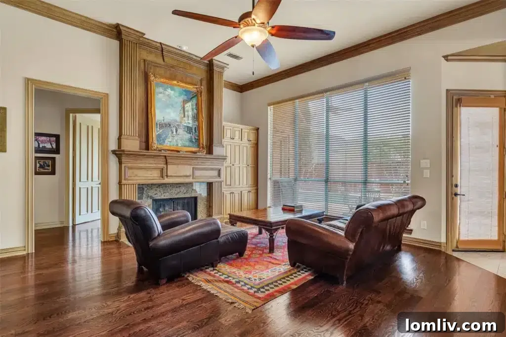 Family room with hardwood floors, a gas log fireplace, and warm wood trim.